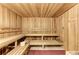 Relaxing sauna with wooden benches and a bucket at 20710 Saluti Pl, Venice, FL 34293