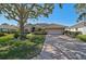 House exterior showcasing a driveway and landscaping at 2173 Muskogee Trl, Nokomis, FL 34275