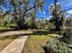 Landscaped backyard with a stone path and lush greenery at 2704 Barret Ave, Plant City, FL 33566