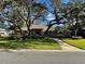 Brick home with lush landscaping and a large yard at 2704 Barret Ave, Plant City, FL 33566