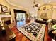 Open living room with hardwood floors, a fireplace, and large windows at 2704 Barret Ave, Plant City, FL 33566