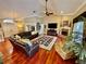 Spacious living room with hardwood floors, fireplace, and a large sectional sofa at 2704 Barret Ave, Plant City, FL 33566