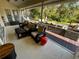 Spacious screened porch, wicker furniture, view of backyard and deck at 2704 Barret Ave, Plant City, FL 33566