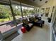 Relaxing screened porch with wicker furniture overlooking the deck and backyard at 2704 Barret Ave, Plant City, FL 33566