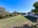 Backyard with pond view, lawn, and white fence at 2824 47Th E St, Palmetto, FL 34221