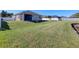 Large backyard with grassy area and fenced enclosure at 2824 47Th E St, Palmetto, FL 34221