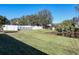 Large backyard with pond, grass lawn and fence at 2824 47Th E St, Palmetto, FL 34221