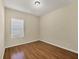 Bright bedroom featuring wood-look flooring and a window with blinds at 2824 47Th E St, Palmetto, FL 34221