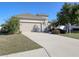 Tan house with a two-car garage and landscaped yard at 2824 47Th E St, Palmetto, FL 34221