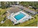 Aerial view of community pool, surrounding patio, and parking at 2925 29Th W Ave, Bradenton, FL 34205
