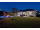 Backyard at night with pool, covered patio and fire pit at 3407 155Th E Ave, Parrish, FL 34219