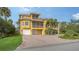 Beautiful yellow house with a two car garage and palm trees at 343 S Orchid Dr, Ellenton, FL 34222