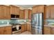 Modern kitchen with stainless steel appliances and light wood cabinets at 343 S Orchid Dr, Ellenton, FL 34222