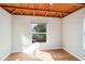 Well-lit bedroom, wood ceiling, hardwood floors and window at 349 Scott Ave, Sarasota, FL 34243