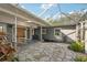 Stone courtyard with covered patio and screened enclosure at 349 Scott Ave, Sarasota, FL 34243