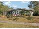 Ranch style home with a large lawn and palm trees at 349 Scott Ave, Sarasota, FL 34243