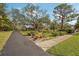 Mature oak tree and landscape pathway leading to home at 349 Scott Ave, Sarasota, FL 34243