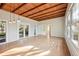 Living room with hardwood floors, wood-beamed ceiling and built-in shelving at 349 Scott Ave, Sarasota, FL 34243