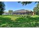 Landscaped backyard with screened pool and spa at 3861 Royal Hammock Blvd, Sarasota, FL 34240