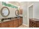 Double vanity bathroom with granite countertops and oval mirrors at 3861 Royal Hammock Blvd, Sarasota, FL 34240