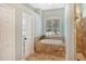 Spa-like bathroom with soaking tub, walk-in shower, and window at 3861 Royal Hammock Blvd, Sarasota, FL 34240