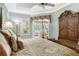 Spacious main bedroom with pool view and large wooden armoire at 3861 Royal Hammock Blvd, Sarasota, FL 34240