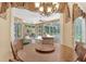 Breakfast nook with a wood table and chairs, overlooking the Gathering room and pool at 3861 Royal Hammock Blvd, Sarasota, FL 34240