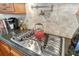 Gas cooktop with stainless steel accents in a kitchen with granite countertops at 3861 Royal Hammock Blvd, Sarasota, FL 34240