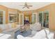 Bright covered patio furnished with seating and views of the backyard at 3861 Royal Hammock Blvd, Sarasota, FL 34240