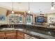 Kitchen island with granite countertop, offering casual seating and views of the Gathering room and pool at 3861 Royal Hammock Blvd, Sarasota, FL 34240