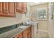 Laundry room with granite countertop and ample cabinetry at 3861 Royal Hammock Blvd, Sarasota, FL 34240