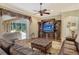Spacious living room with leather sofas, hardwood floors, and a view of the pool at 3861 Royal Hammock Blvd, Sarasota, FL 34240