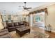 Living room with leather furniture, hardwood floors and views to the kitchen and pool at 3861 Royal Hammock Blvd, Sarasota, FL 34240