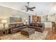Living room with leather sofas, hardwood floors, and views to kitchen and pool at 3861 Royal Hammock Blvd, Sarasota, FL 34240