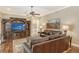 Living room with leather furniture, hardwood floors, and access to the pool area at 3861 Royal Hammock Blvd, Sarasota, FL 34240