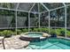 Spa and pool with screened enclosure and lush landscaping at 3861 Royal Hammock Blvd, Sarasota, FL 34240