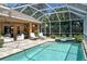 Expansive screened pool and spa with covered patio at 3861 Royal Hammock Blvd, Sarasota, FL 34240