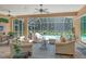 Spacious screened lanai with seating, pool and lush greenery at 3861 Royal Hammock Blvd, Sarasota, FL 34240
