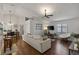 Living room with hardwood floors, sectional sofa, and access to the kitchen and bedroom at 3911 Penrod Ln, Valrico, FL 33596