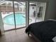 Bedroom with pool view and sliding glass doors at 417 Avenida De Mayo, Sarasota, FL 34242