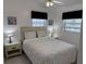 Bright bedroom with a queen bed, nightstands, and window coverings at 417 Avenida De Mayo, Sarasota, FL 34242