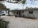 Single story home with gravel driveway and small yard at 417 Avenida De Mayo, Sarasota, FL 34242