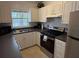 Cozy kitchen with white cabinets and stainless steel appliances at 417 Avenida De Mayo, Sarasota, FL 34242
