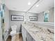 Bathroom with granite countertops, a double vanity, and a shower at 4215 Gulf Of Mexico Dr # 103, Longboat Key, FL 34228