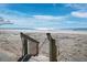 Steps lead to a pristine beach with beautiful ocean views at 4215 Gulf Of Mexico Dr # 103, Longboat Key, FL 34228