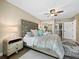 Guest bedroom with a queen-size bed and a ceiling fan at 4215 Gulf Of Mexico Dr # 103, Longboat Key, FL 34228