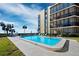 Inviting community pool with ample lounge chairs, ready for relaxation at 4215 Gulf Of Mexico Dr # 103, Longboat Key, FL 34228
