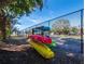 Kayaks stored on a rack near a tennis court at 4215 Gulf Of Mexico Dr # 103, Longboat Key, FL 34228