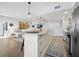 Modern kitchen with granite island, white cabinets, and stainless steel appliances at 4215 Gulf Of Mexico Dr # 103, Longboat Key, FL 34228