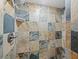 Shower with multi-colored stone tile and modern fixtures at 4215 Gulf Of Mexico Dr # 103, Longboat Key, FL 34228